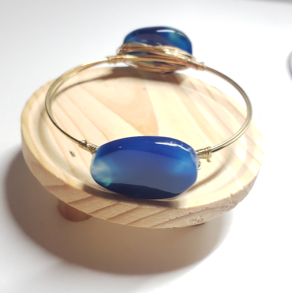 Gold bangle with blue stones